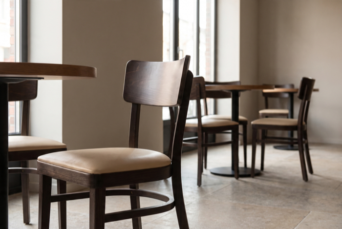 Holzstuhl mit Polstersitz an Restauranttisch