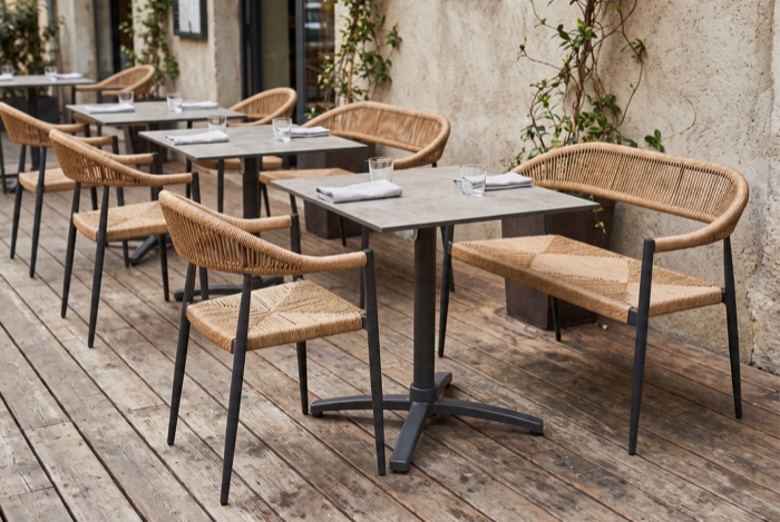 Outdoor-Stühle an Tischen auf Holzterrasse
